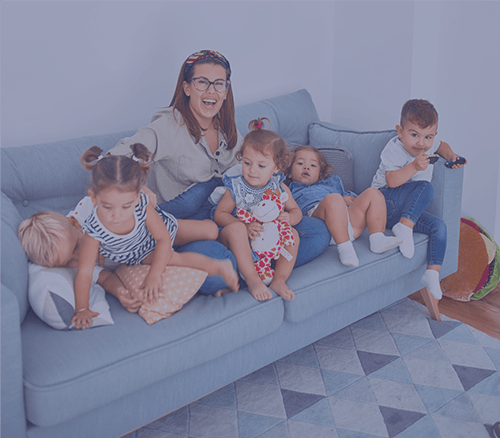 a happy sitting on the couch with children